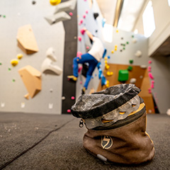 young blonde girl bouldering