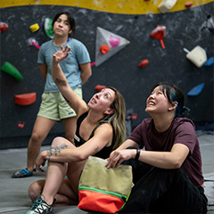 woman lead climbing in gym