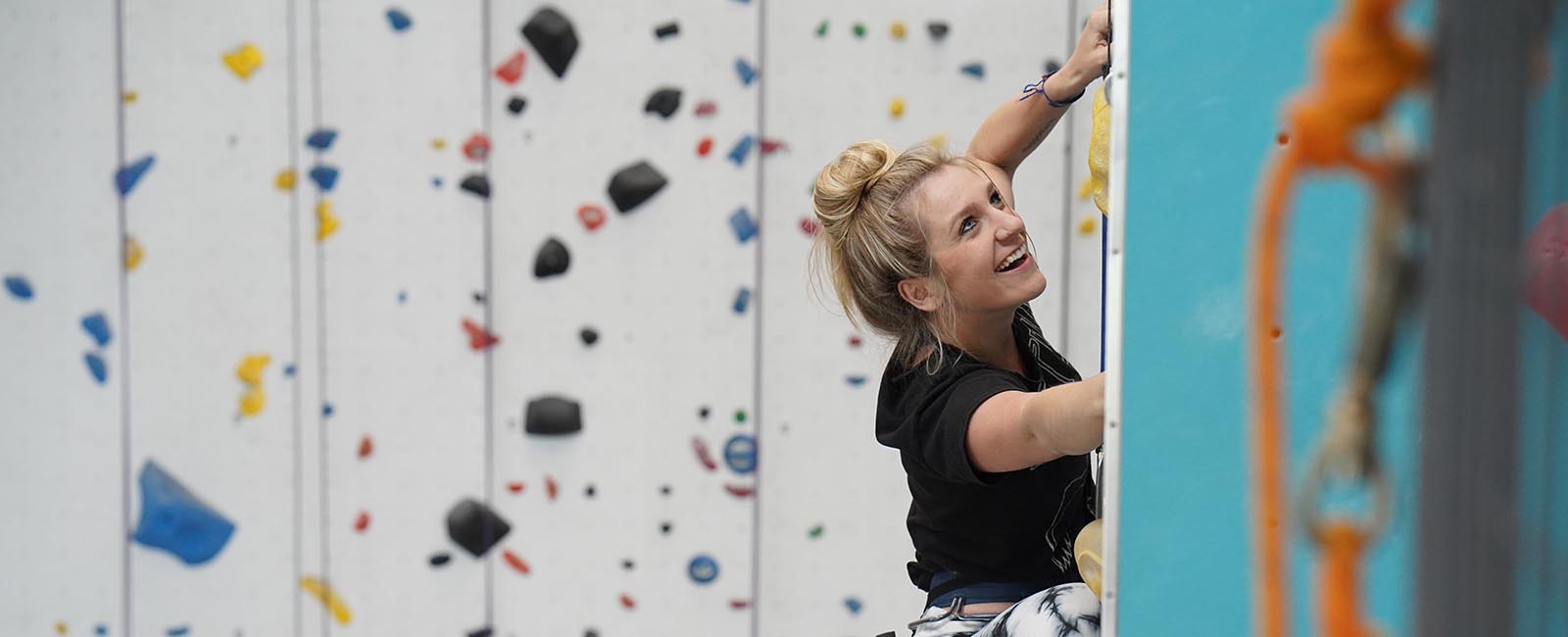 woman climbing on top rope
