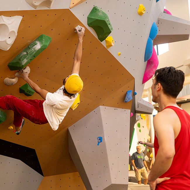 young blonde girl bouldering